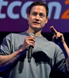 Photo shows longevity influencer Bryan Johnson speaking at a Bitcoin event earlier this year