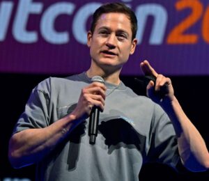 Photo shows longevity influencer Bryan Johnson speaking at a Bitcoin event earlier this year