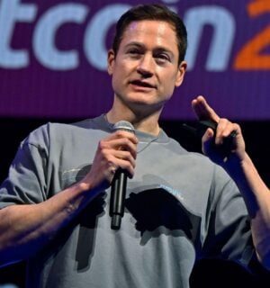 Photo shows longevity influencer Bryan Johnson speaking at a Bitcoin event earlier this year