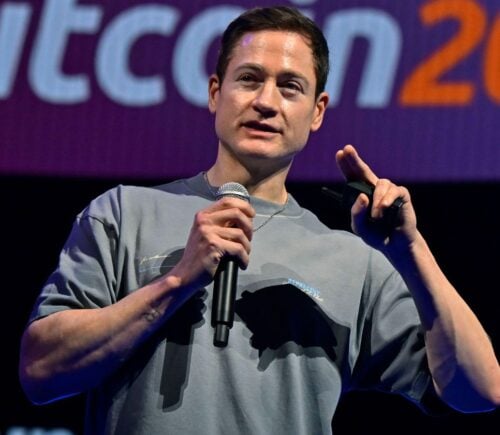 Photo shows longevity influencer Bryan Johnson speaking at a Bitcoin event earlier this year