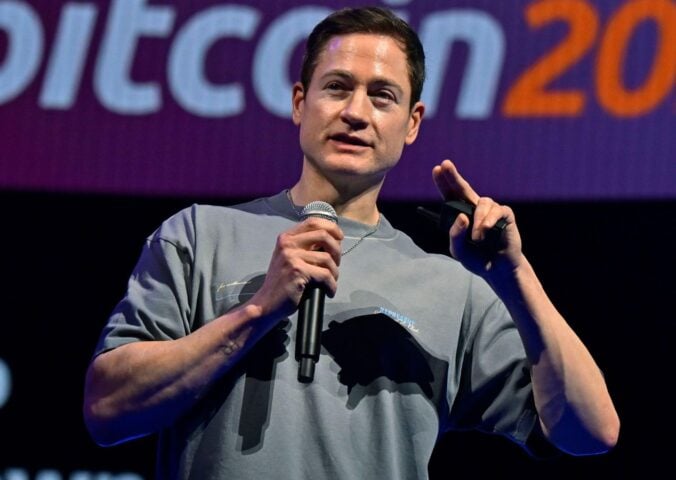 Photo shows longevity influencer Bryan Johnson speaking at a Bitcoin event earlier this year