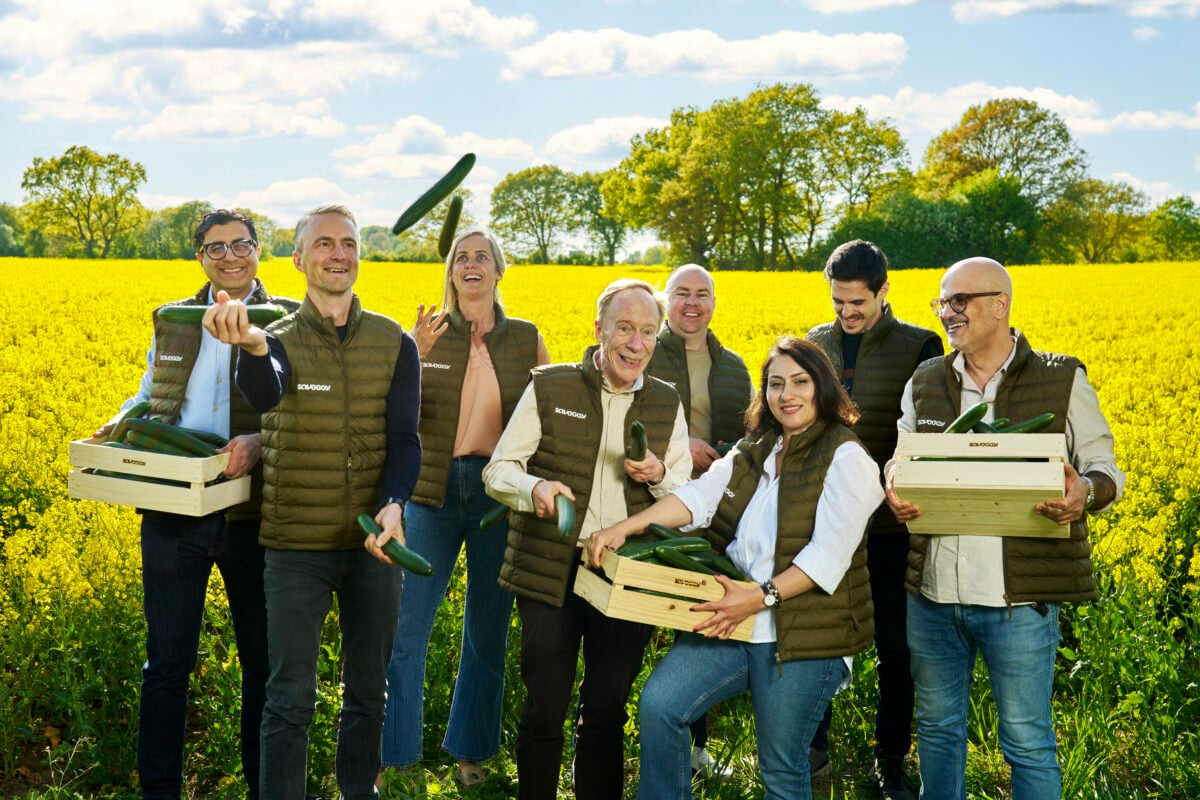 Photo shows the Saveggy team with boxes of cucumbers in front of a field of rapeseed, one of the company's two star ingredients