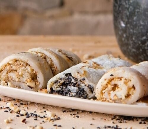vegan fried mochi rolls with peanuts, walnuts, oats, and white and black sesame seeds