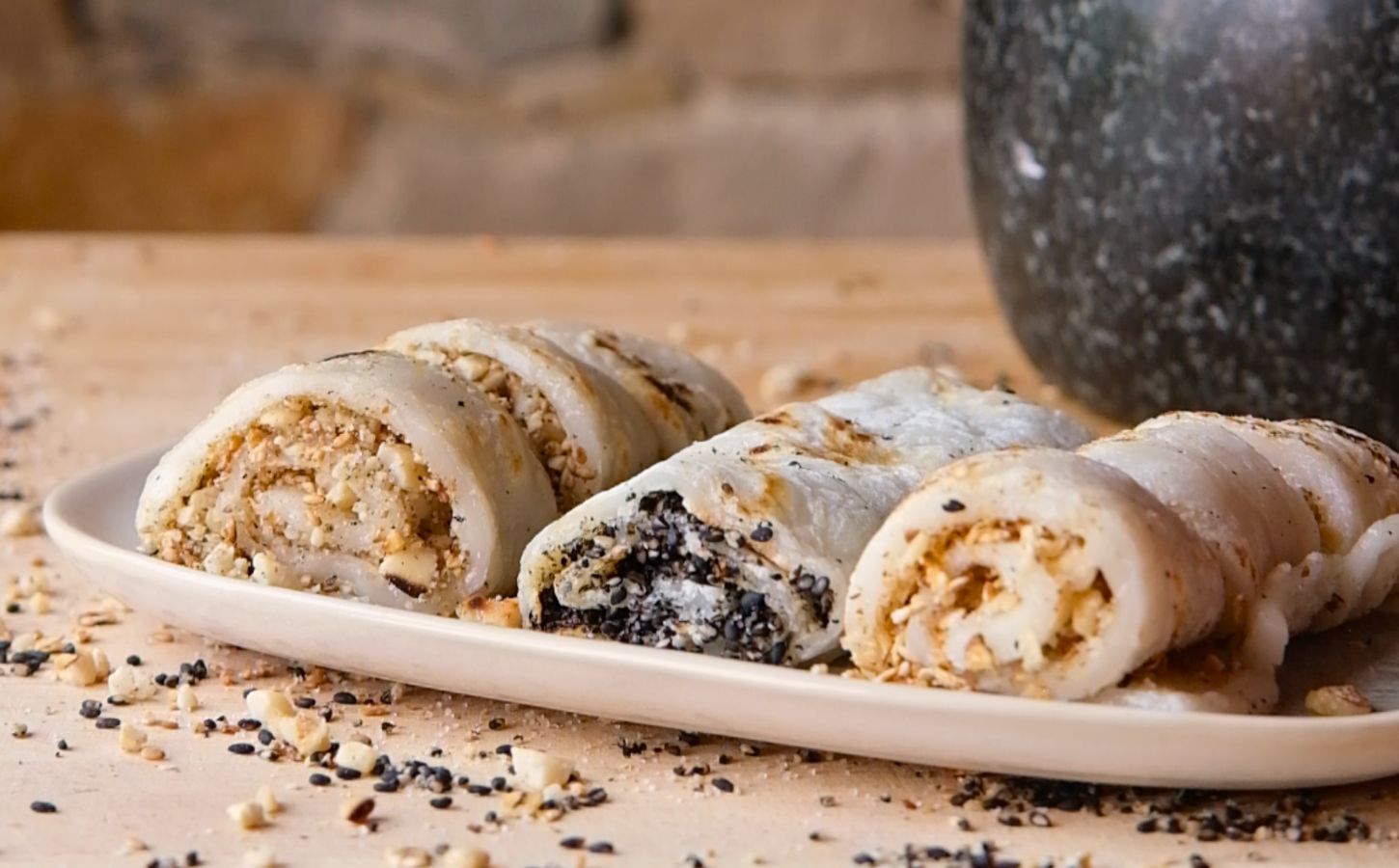 vegan fried mochi rolls with peanuts, walnuts, oats, and white and black sesame seeds