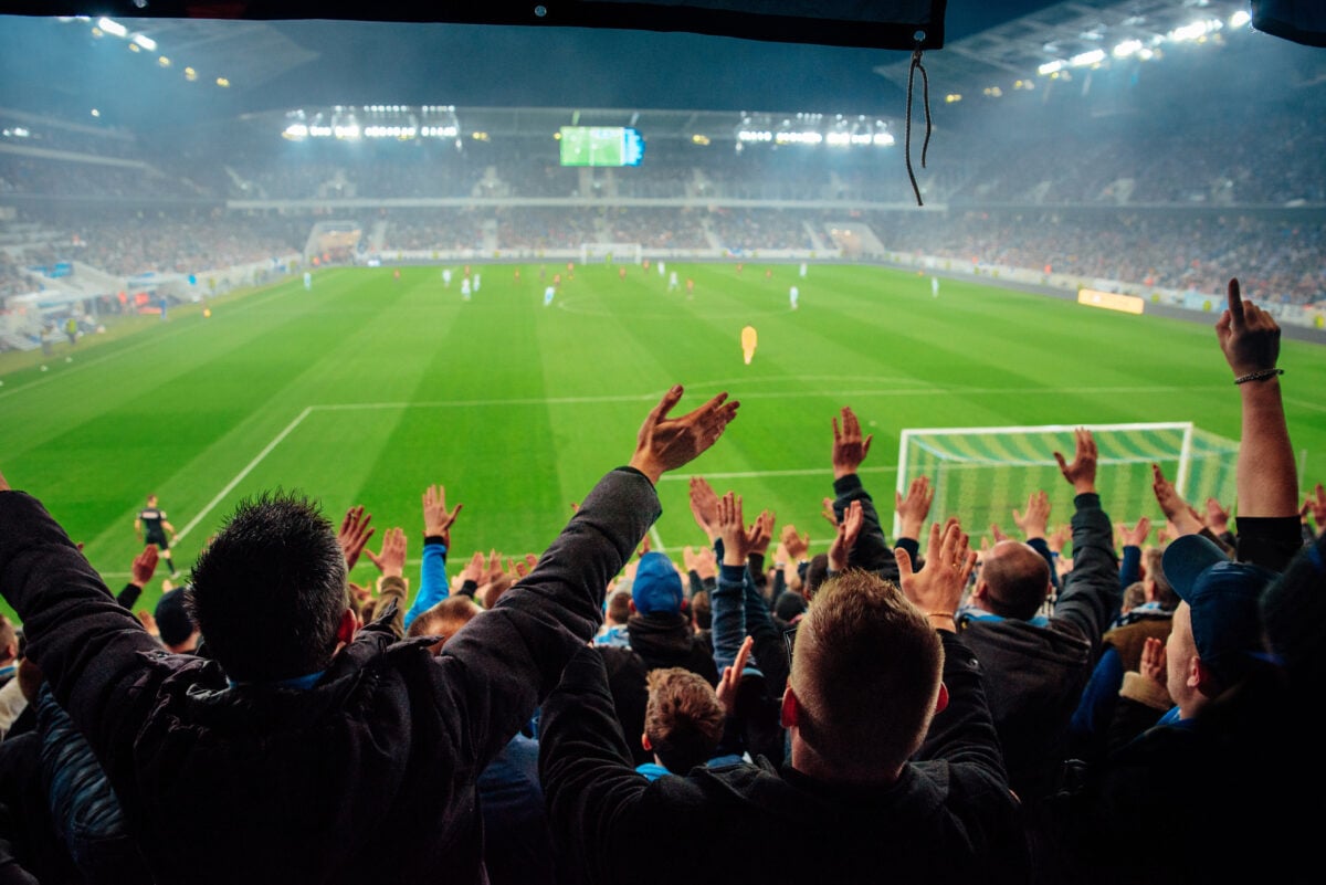 Photo shows a crowd at a football stadium. Hector Bellerin is a vegan footballer who plays for Spain's Real Betis