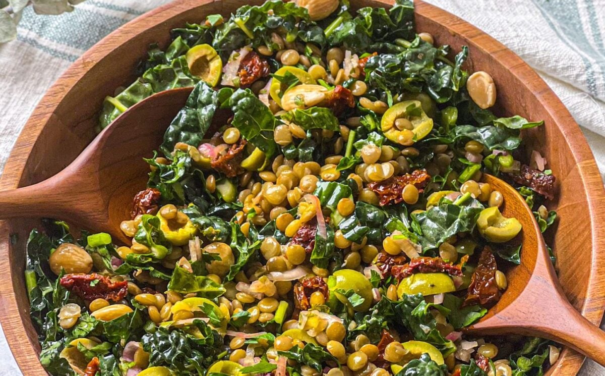 a picture of a lemon and pesto lentil salad made with olives, sundried tomatoes, kale, and almonds for high-protein vegan recipes