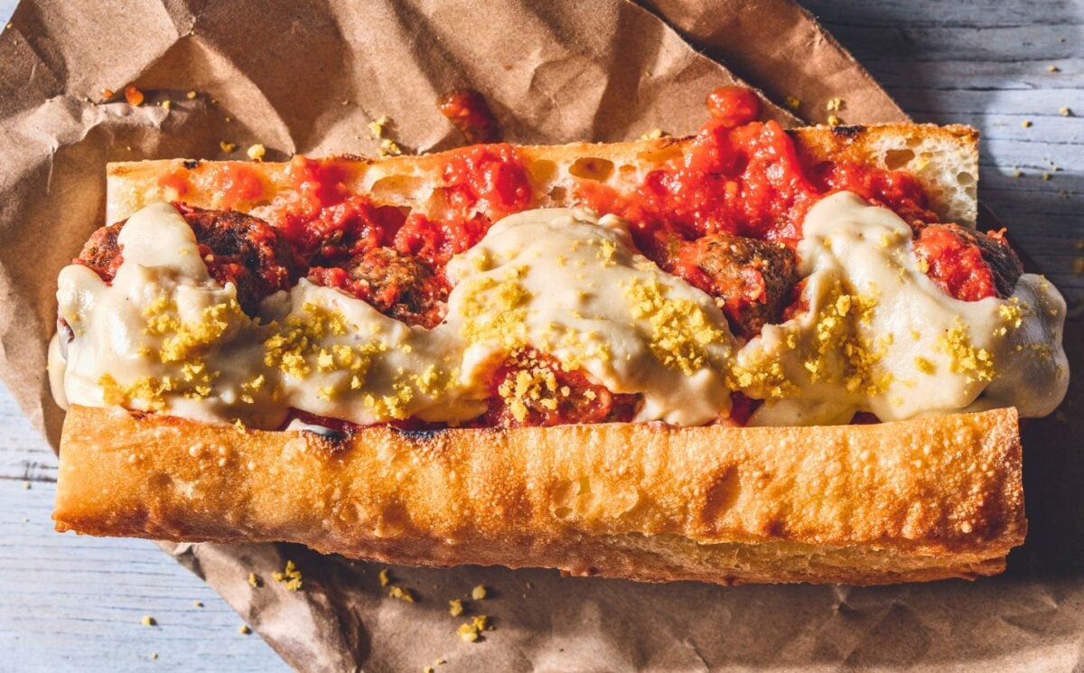 a vegan meatball parmigiana hero with cashew mozzarella, lentil meatballs, and basil for cozy lunch recipes for fall