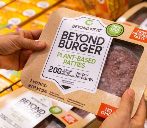 Photo shows someone's hands as they hold up a package of Beyond Burgers. "Burger" and other meat words may soon be banned from plant-based food labels in Europe