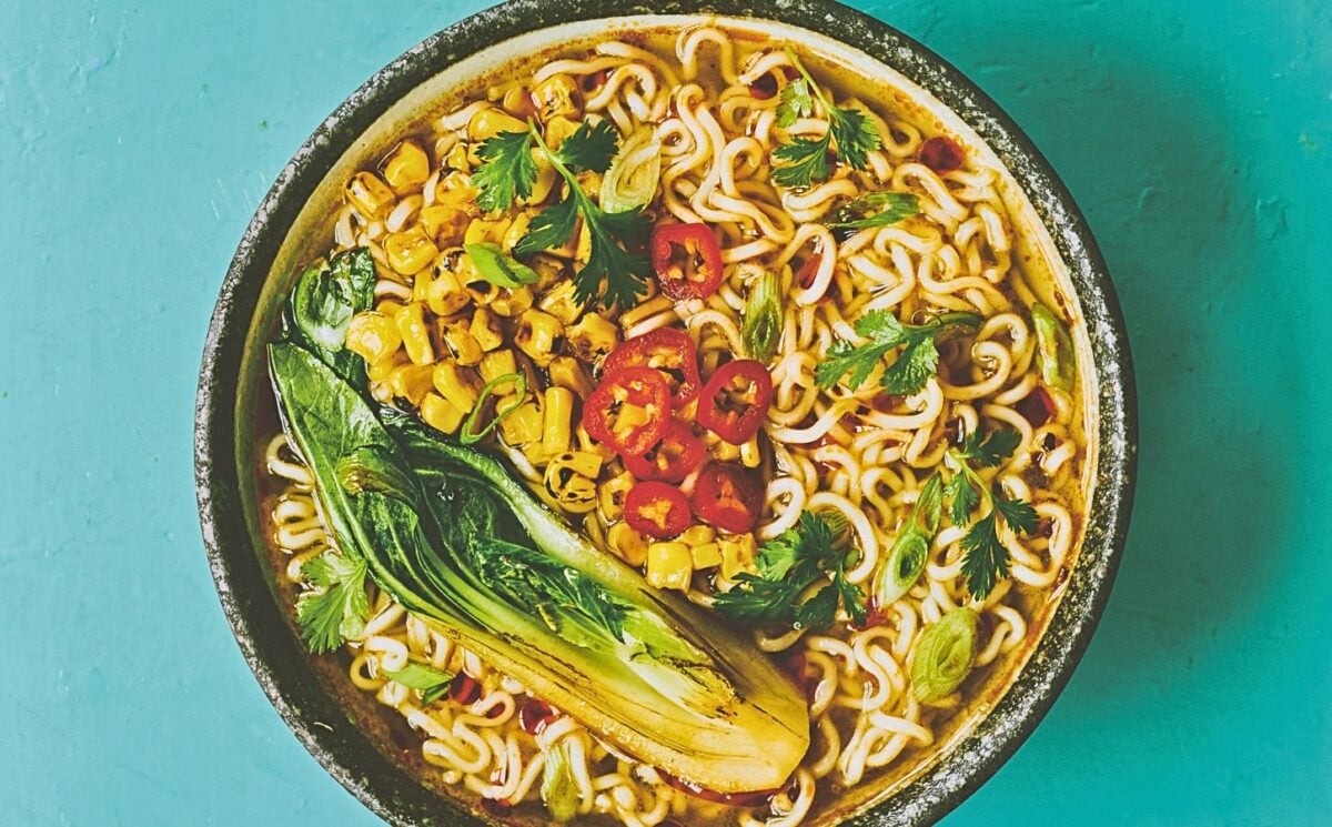 a bowl of pimped instant ramen with corn, chili, and bak choy for ramen recipes for chilly days