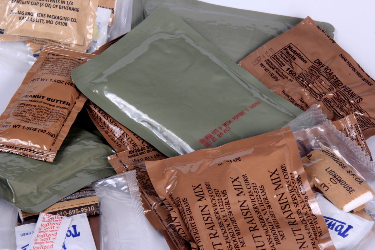 Photo shows a pile of sachets from military rations, including roasted peanuts and raisins