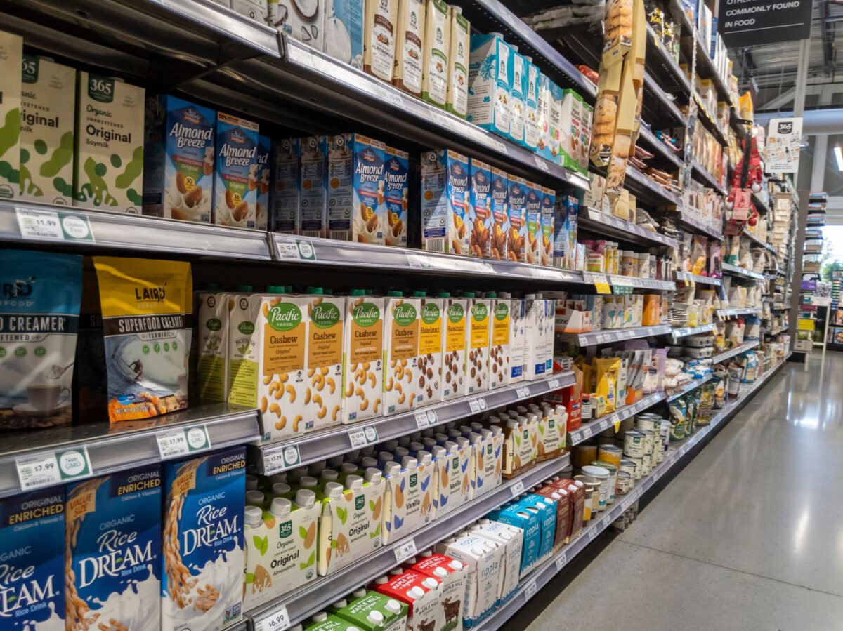 Photo shows a selection of plant-based milk products on supermarket shelves