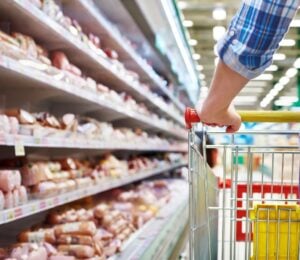 Photo shows someone with a shopping trolley in the meet aisle. Some plant-based proteins are currently cheaper than traditional meat