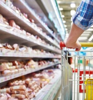 Photo shows someone with a shopping trolley in the meet aisle. Some plant-based proteins are currently cheaper than traditional meat