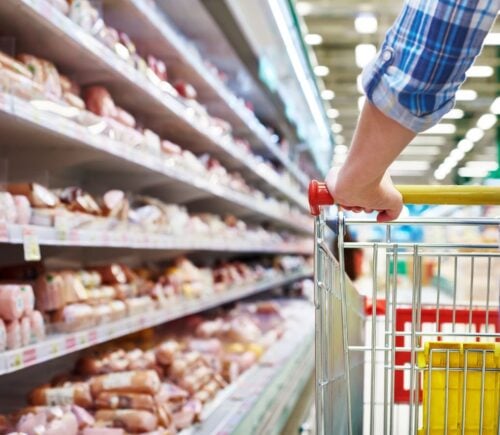 Photo shows someone with a shopping trolley in the meet aisle. Some plant-based proteins are currently cheaper than traditional meat