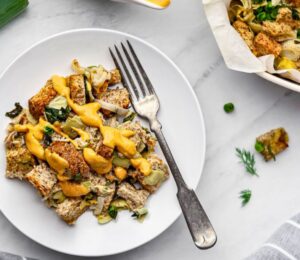 plant based savory bread pudding with nutritional yeast and spinach