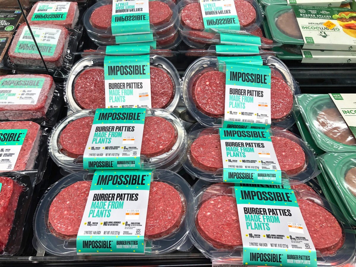 Photo shows a grocery store refrigerator filled with Impossible Foods burgers