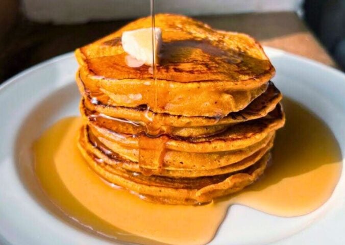 pumpkin spiced latte pancakes with ground coffee and maple syrup