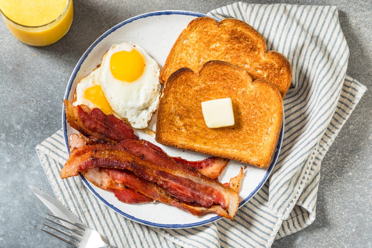 Photo shows a plate of bacon, eggs, and buttered toast