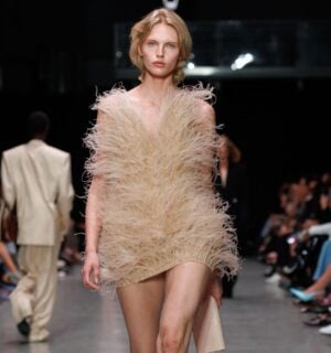 Photo shows a model at Paris Fashion Week wearing a Stella McCartney dress featuring vegan feathers from London-based company FEVVERS