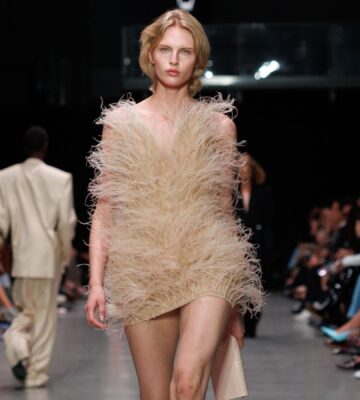 Photo shows a model at Paris Fashion Week wearing a Stella McCartney dress featuring vegan feathers from London-based company FEVVERS
