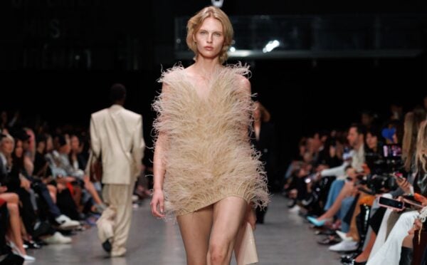 Photo shows a model at Paris Fashion Week wearing a Stella McCartney dress featuring vegan feathers from London-based company FEVVERS