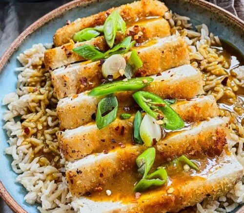 tofu katsu curry with brown rice, carrot and onion curry, and a panko-covered piece of tofu