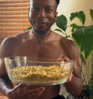 Shai Rowe holds a glass bowl with sprouted lentils, displaying the results of sprouting lentils at home