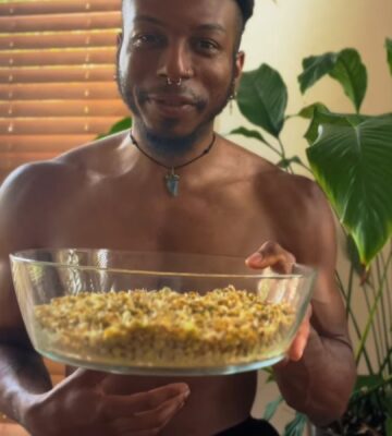Shai Rowe holds a glass bowl with sprouted lentils, displaying the results of sprouting lentils at home
