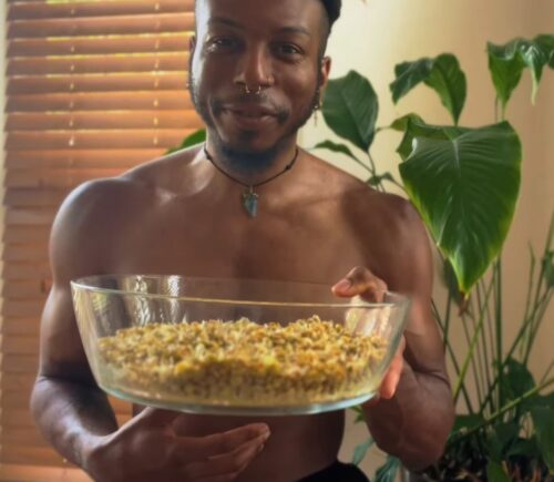 Shai Rowe holds a glass bowl with sprouted lentils, displaying the results of sprouting lentils at home