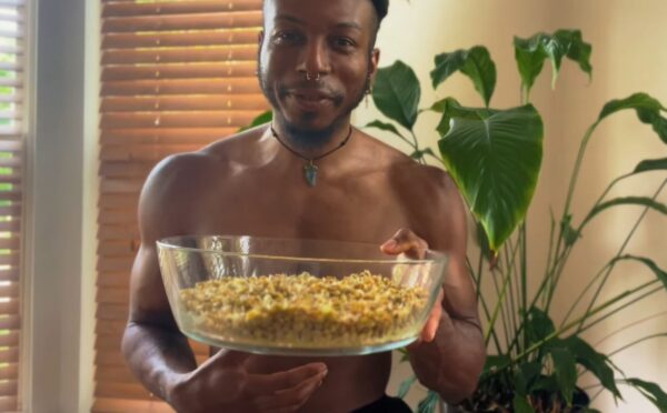 Shai Rowe holds a glass bowl with sprouted lentils, displaying the results of sprouting lentils at home