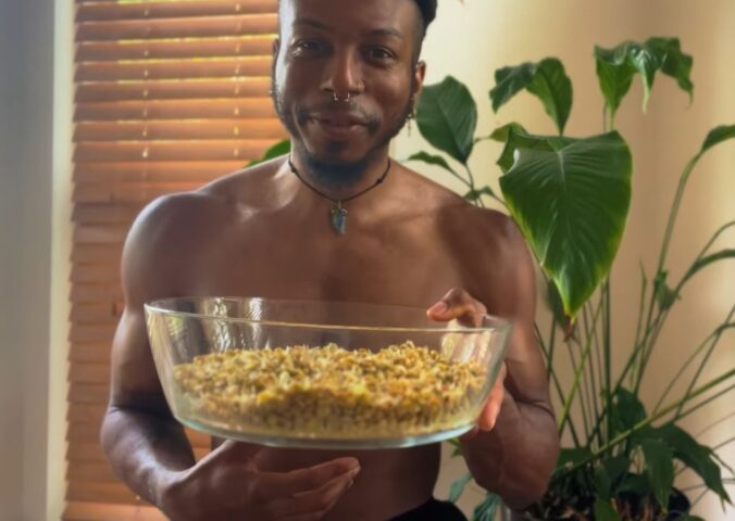 Shai Rowe holds a glass bowl with sprouted lentils, displaying the results of sprouting lentils at home