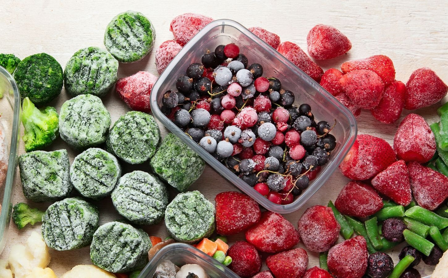 frozen fruits, berries, spinach and other vegetables in a picture together for why frozen produce might be healthier than fresh