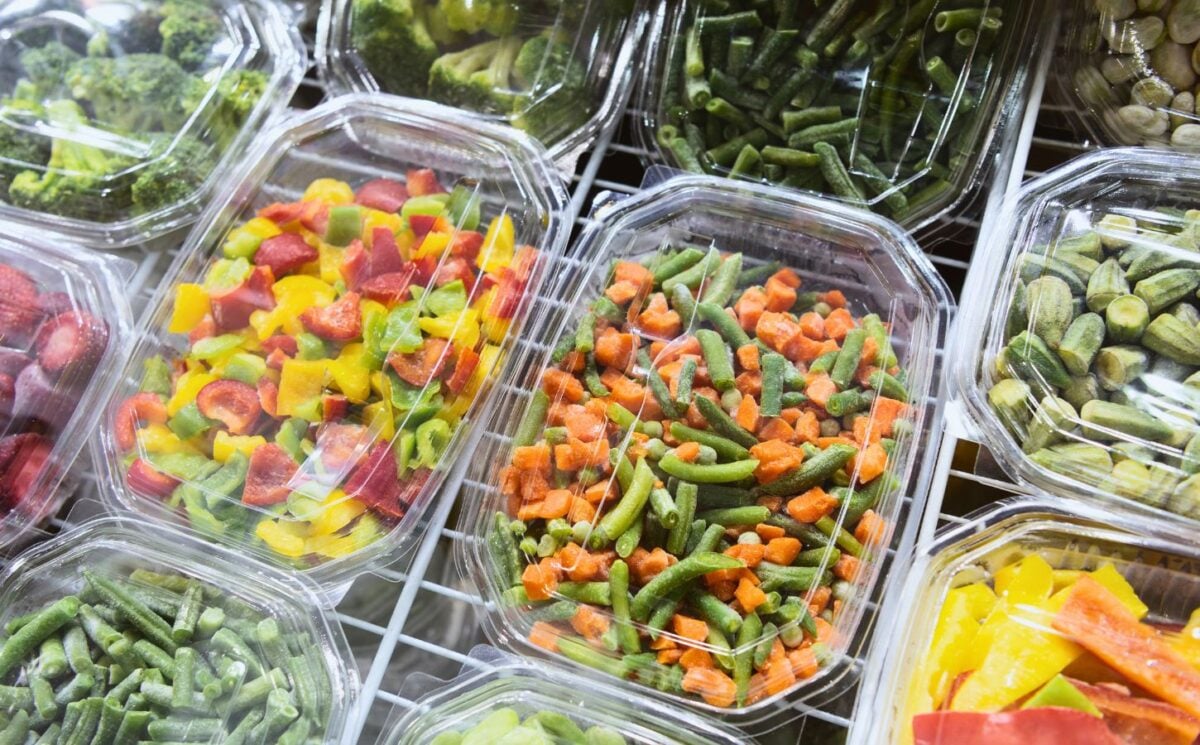 frozen fruits, berries, spinach and other vegetables in a picture together for why frozen produce might be healthier than fresh