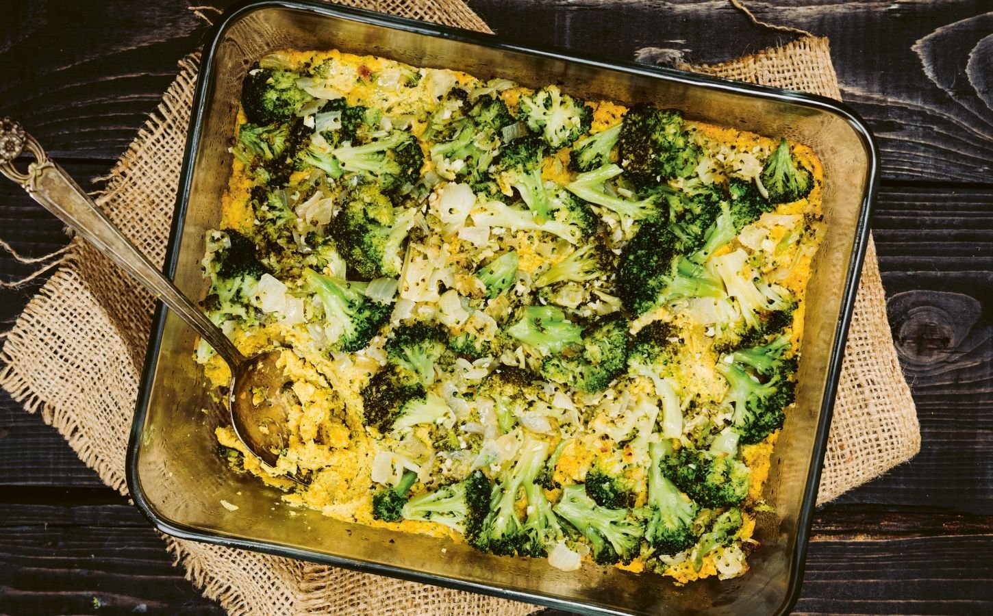 a picture of a vegan cheesy broccoli bake made with silken tofu, nutritional yeast, paprika, and tahini for easy casserole recipes
