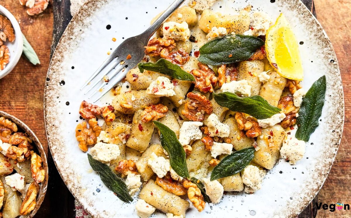 a plate of homemade gnocchi with sage, walnuts, and vegan blue cheese