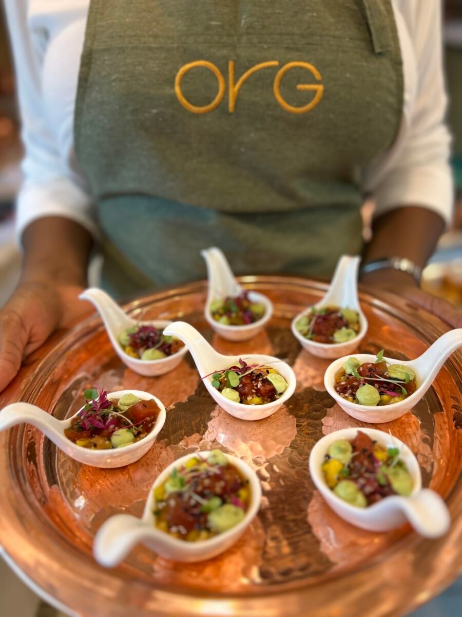 Photo shows someone from .Org Bistrô holding a tray of vegan tuna fish flavored with wasabi