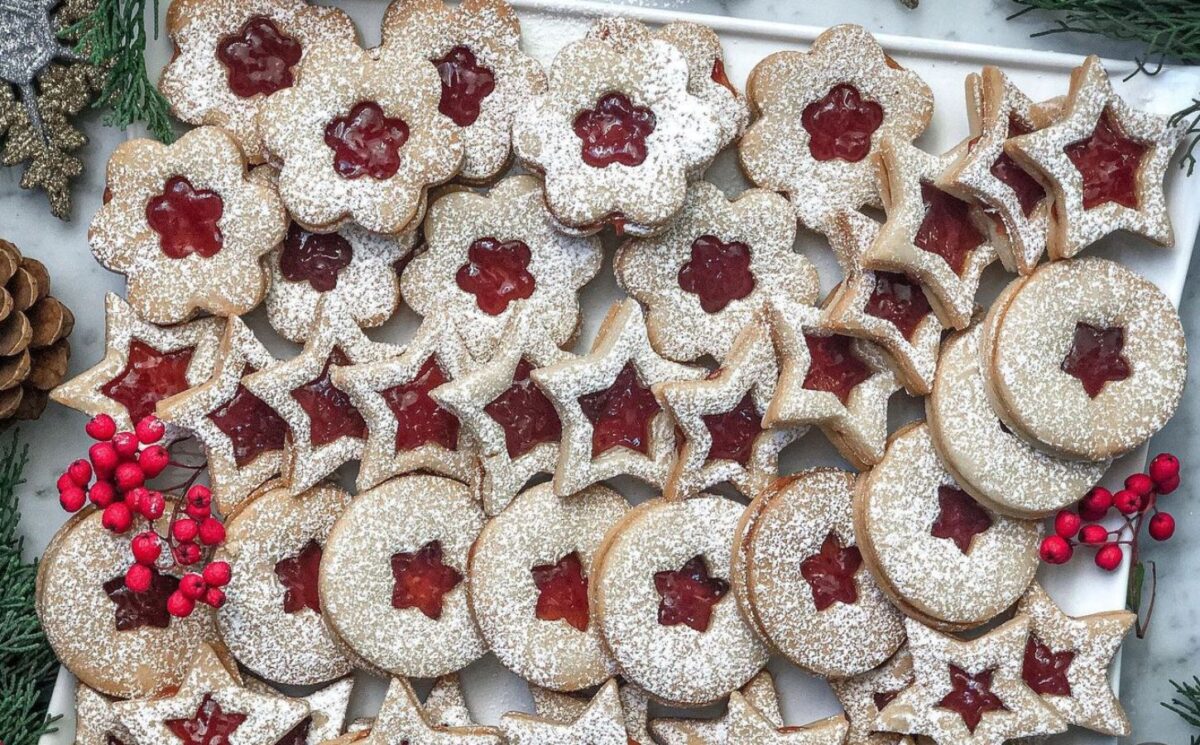 a tray of linzer cookies with strawberry jam