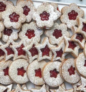 a tray of linzer cookies with strawberry jam