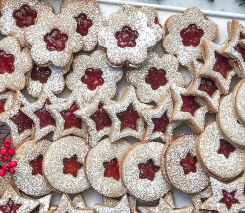 a tray of linzer cookies with strawberry jam