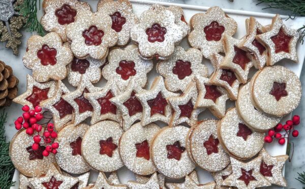 a tray of linzer cookies with strawberry jam