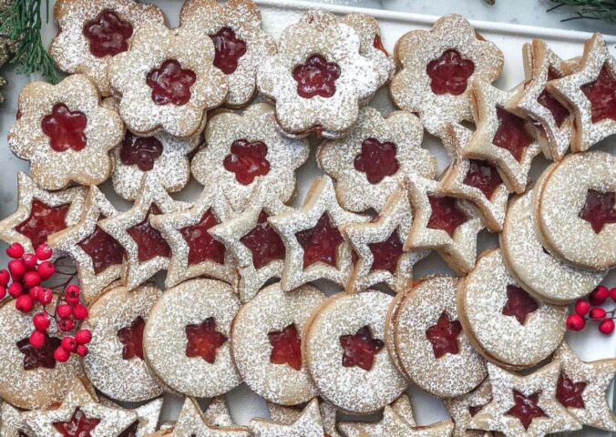 a tray of linzer cookies with strawberry jam