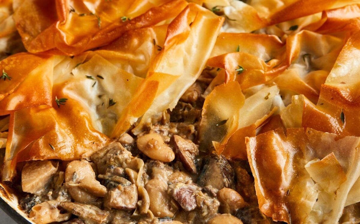 a picture of a mushroom and butterbean filo pie made with artichokes and banana shallots for easy vegan thanksgiving recipes