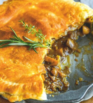 a mushroom and Guinness pie made with vegan puff pastry, cremini mushrooms, Guinness and seasonings for vegan British recipes