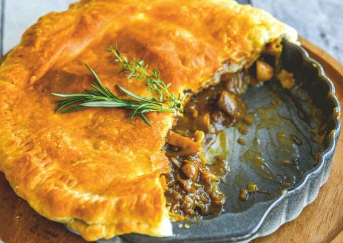 a mushroom and Guinness pie made with vegan puff pastry, cremini mushrooms, Guinness and seasonings for vegan British recipes