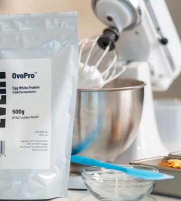 Photo shows a bag of The Every Company's powdered, precision fermented egg protein next to baking equipment and two small cakes