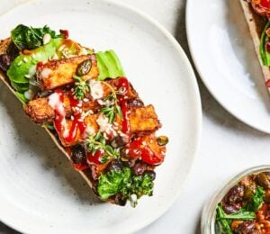 a plate of sizzling tofu, kale and black bean toast