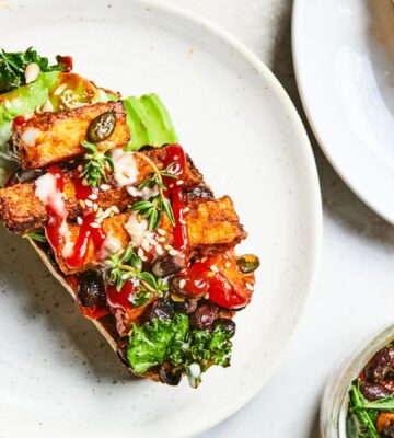 a plate of sizzling tofu, kale and black bean toast