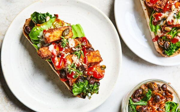 a plate of sizzling tofu, kale and black bean toast