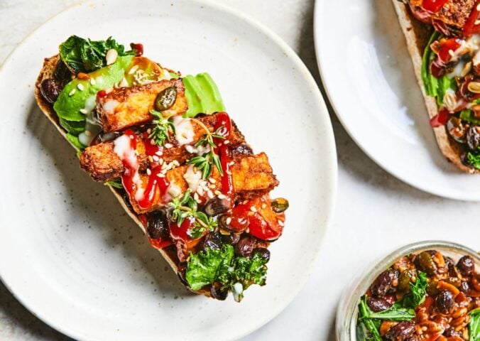 a plate of sizzling tofu, kale and black bean toast