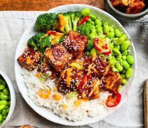 sticky gochujang tofu bowl with edamame, broccoli, and kimchi